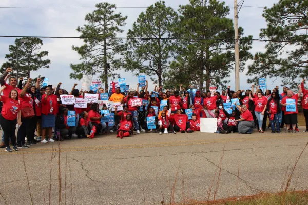 Maximus workers take a group photo while on strike